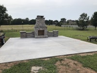 a concrete patio with a fire pit in the middle