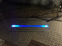 a walkway with a blue light in the middle
