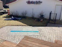a brick paver patio with a blue flag on it